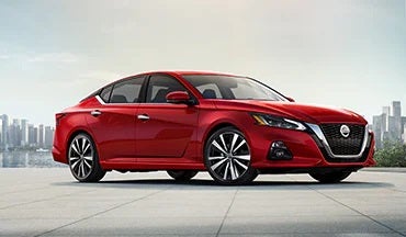 2023 Nissan Altima in red with city in background illustrating last year's 2022 model in Dutch Miller Nissan in Bristol TN