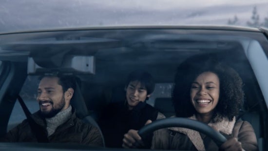 Three passengers riding in a vehicle and smiling | Dutch Miller Nissan in Bristol TN