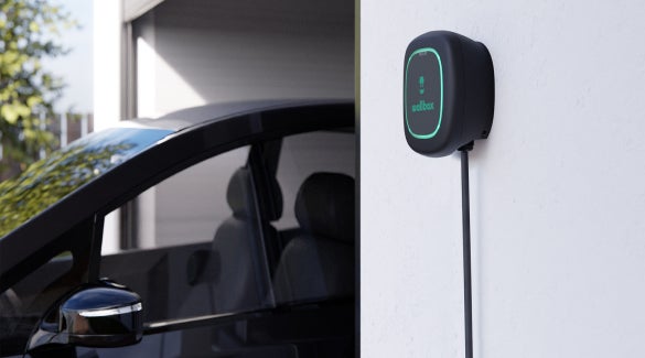 Zoomed-in shot of Nissan ARIYA near a charging cable, not plugged in | Dutch Miller Nissan Of Bristol in Bristol TN