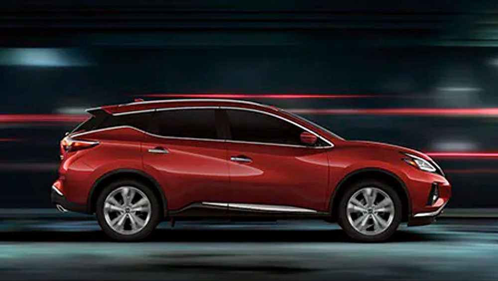 2023 Nissan Murano shown in profile driving down a street at night illustrating performance. | Dutch Miller Nissan Of Bristol in Bristol TN