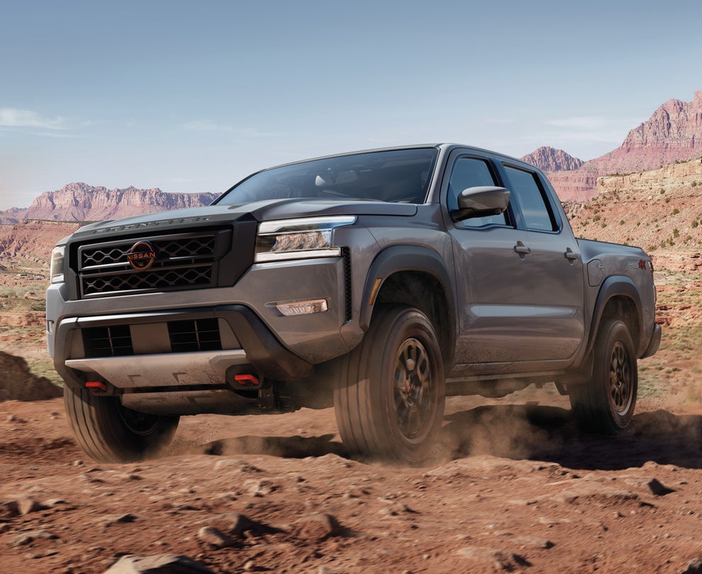 Nissan Frontier driving down desert road