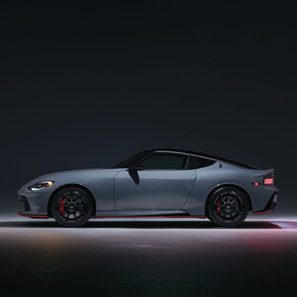 2024 Nissan Z in blue driving on a rural road at speed